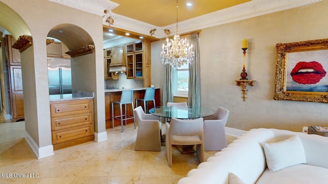 tiled dining area with a chandelier and ornamental molding