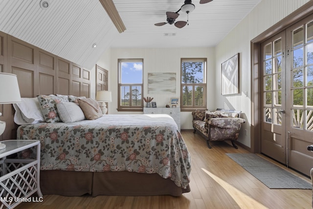 bedroom with hardwood / wood-style flooring, a ceiling fan, and visible vents