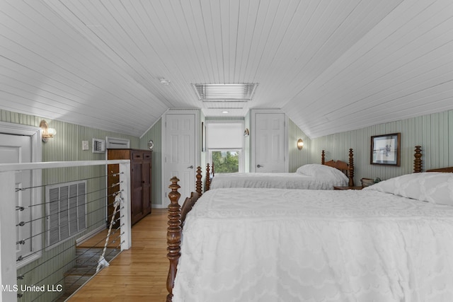 bedroom featuring lofted ceiling, wood ceiling, and wood finished floors