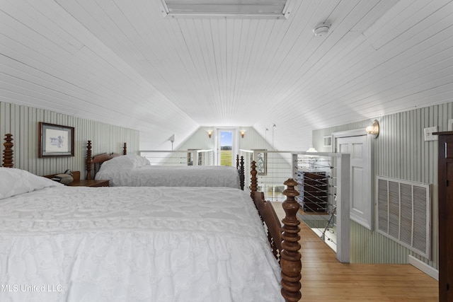 bedroom featuring vaulted ceiling, visible vents, wood ceiling, and wood finished floors