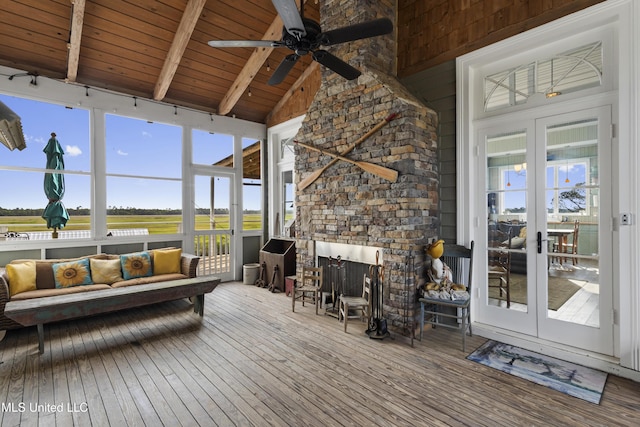 sunroom / solarium with beam ceiling, french doors, and ceiling fan