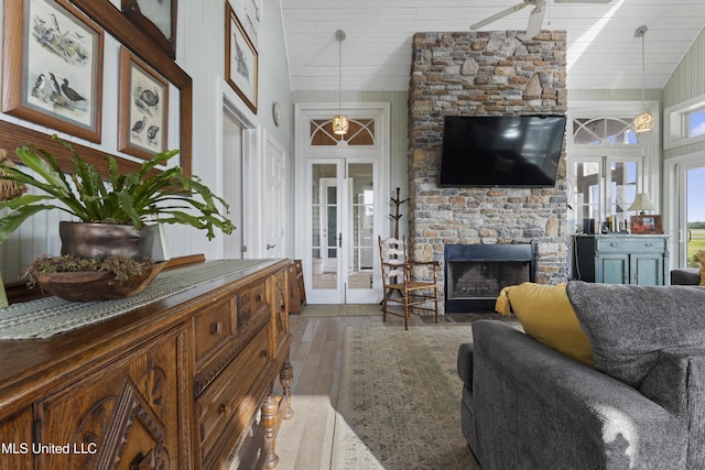 living room featuring wood ceiling, vaulted ceiling, a fireplace, and hardwood / wood-style floors