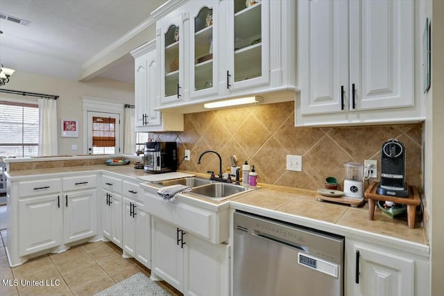 kitchen with visible vents, dishwasher, a peninsula, white cabinetry, and a sink