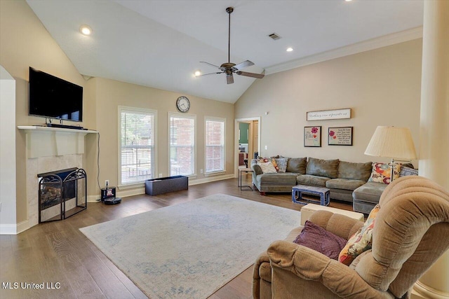 109 Bellemeade Trce, Clinton, MS 39056 - living room with a ceiling fan, vaulted ceiling, a tiled fireplace, wood finished floors, and baseboards