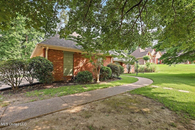 109 Bellemeade Trce, Clinton, MS 39056 - obstructed view of property with brick siding, a front lawn, and a shingled roof