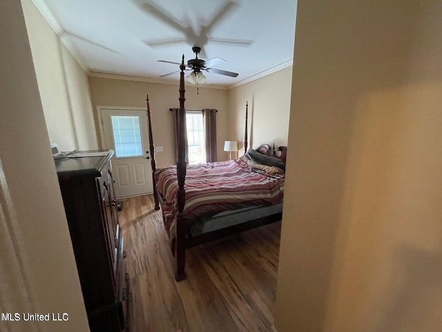 bedroom featuring ornamental molding, wood-type flooring, and ceiling fan