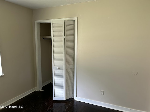 1110 Barbara Ann Dr, Jackson, MS 39204 - unfurnished bedroom with a closet, baseboards, and dark wood finished floors
