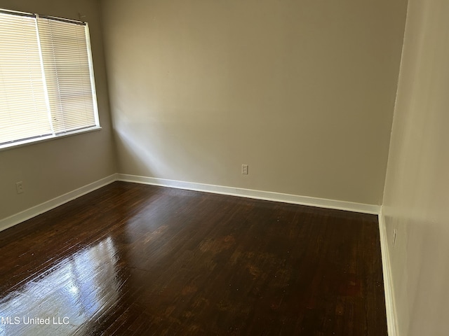 1110 Barbara Ann Dr, Jackson, MS 39204 - empty room with dark wood-type flooring and baseboards