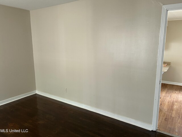 1110 Barbara Ann Dr, Jackson, MS 39204 - empty room featuring dark wood-style floors and baseboards