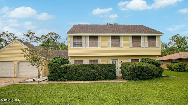 colonial home with concrete driveway, an attached garage, and a front lawn