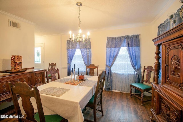 dining area with an inviting chandelier, ornamental molding, a healthy amount of sunlight, and dark wood finished floors