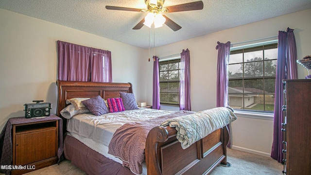 bedroom with carpet flooring, a textured ceiling, baseboards, and ceiling fan