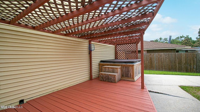 deck with a patio area, a pergola, a hot tub, and fence