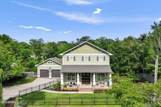 view of front of house featuring a front lawn, a porch, and a garage