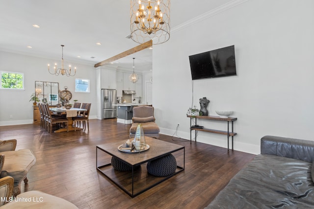 living room with dark hardwood / wood-style flooring, crown molding, and an inviting chandelier