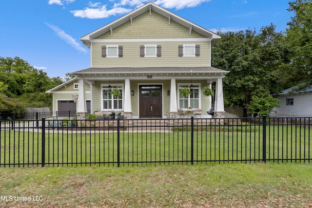 view of front facade featuring a front yard, a garage, and covered porch