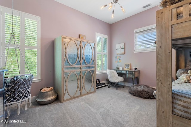 office space with a notable chandelier and carpet floors