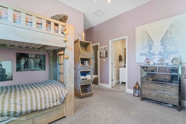 carpeted bedroom featuring ensuite bathroom