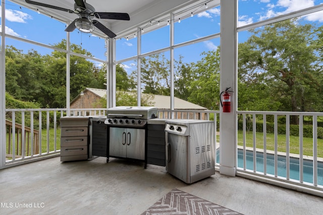 unfurnished sunroom featuring ceiling fan