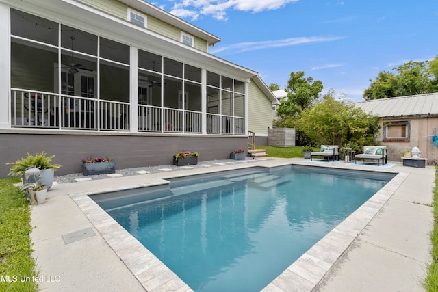 view of pool featuring a sunroom, ceiling fan, and a patio area