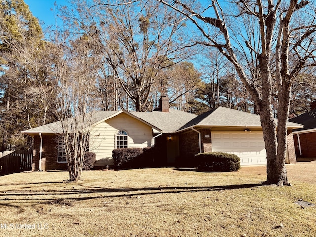 ranch-style home featuring a garage and a front yard