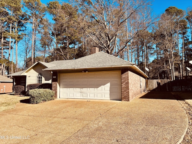 exterior space featuring a garage and an outbuilding