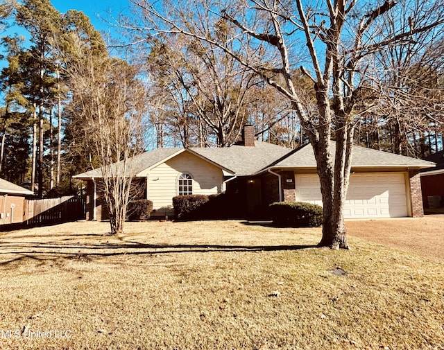 single story home featuring a front yard and a garage