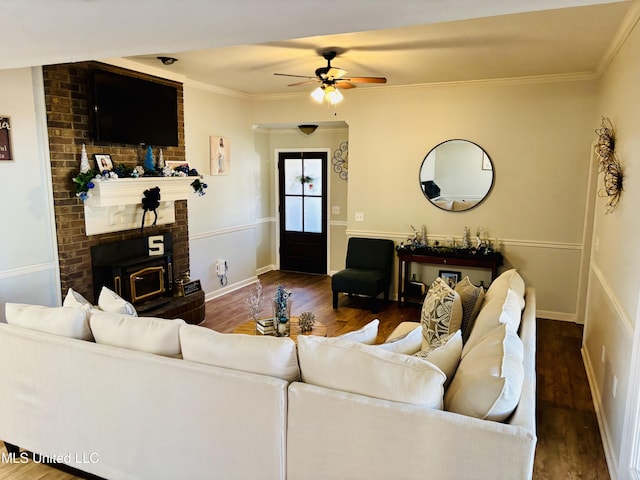 living room featuring ceiling fan, crown molding, and dark hardwood / wood-style floors