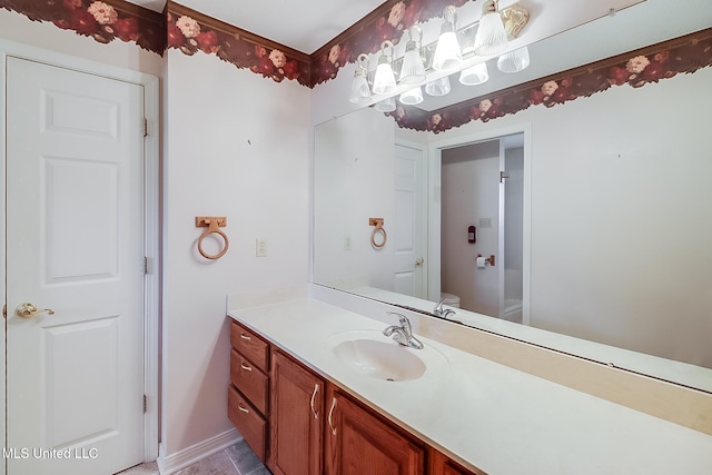 bathroom featuring vanity and toilet