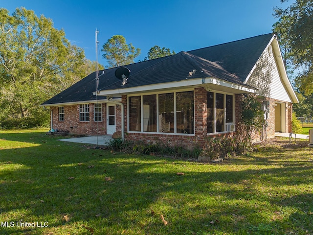 back of property with a patio and a yard