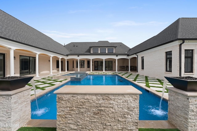 view of swimming pool featuring a patio area and a pool with connected hot tub