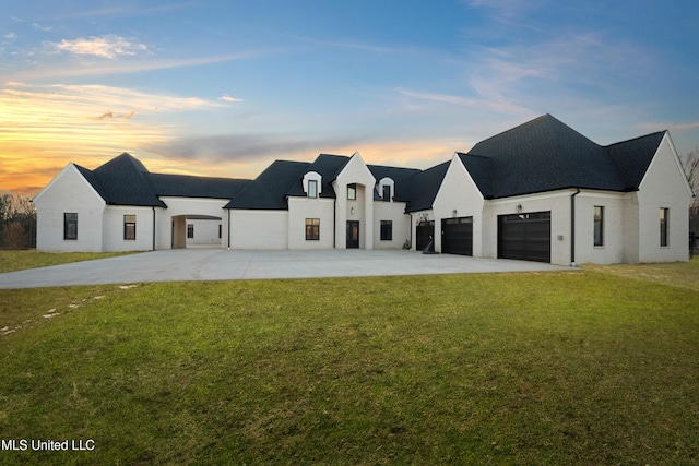 modern farmhouse style home featuring a garage, concrete driveway, and a lawn