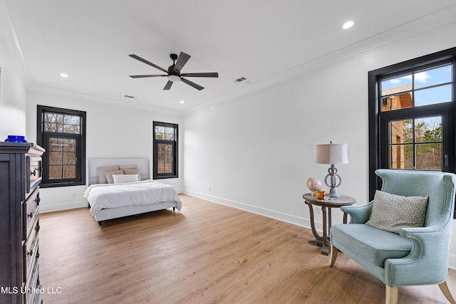 bedroom with ornamental molding, light wood-type flooring, and baseboards