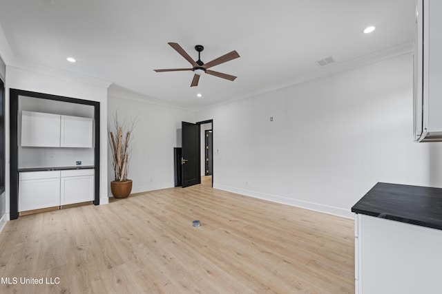 unfurnished living room with light wood finished floors, baseboards, ceiling fan, crown molding, and recessed lighting