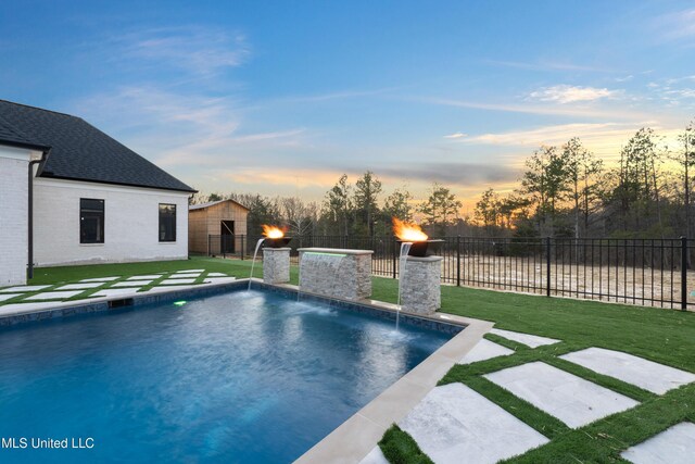 view of pool featuring a patio, a lawn, fence, and a fenced in pool