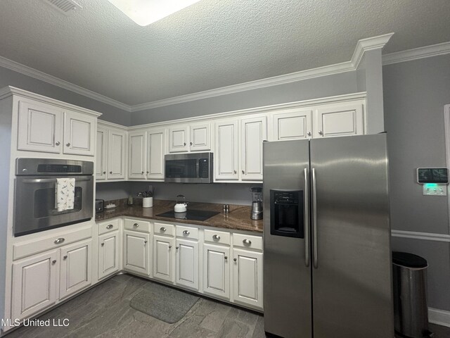 2610 Dickens Place Dr, Southaven, MS 38671 - kitchen featuring appliances with stainless steel finishes, ornamental molding, white cabinetry, and a textured ceiling