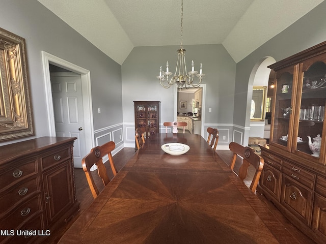 2610 Dickens Place Dr, Southaven, MS 38671 - dining area featuring arched walkways, a decorative wall, a wainscoted wall, a chandelier, and vaulted ceiling