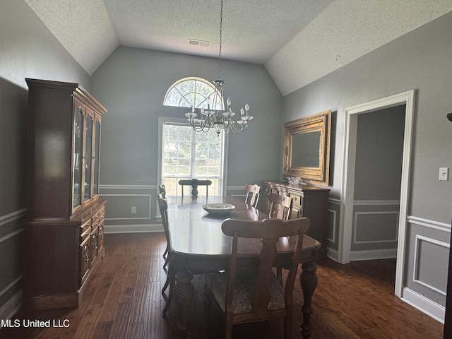 2610 Dickens Place Dr, Southaven, MS 38671 - dining space with dark wood-style flooring, vaulted ceiling, a textured ceiling, a chandelier, and a decorative wall