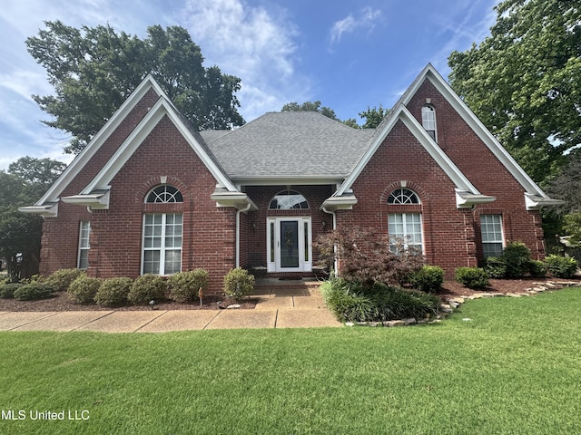 2610 Dickens Place Dr, Southaven, MS 38671 - traditional-style home featuring brick siding, a front lawn, and roof with shingles