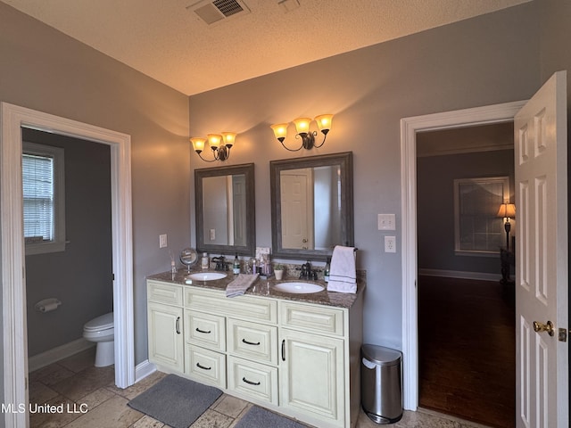 2610 Dickens Place Dr, Southaven, MS 38671 - full bathroom featuring double vanity and a textured ceiling