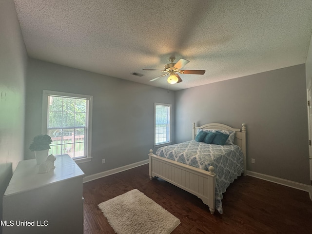 2610 Dickens Place Dr, Southaven, MS 38671 - bedroom with a textured ceiling, dark wood-type flooring, and a ceiling fan