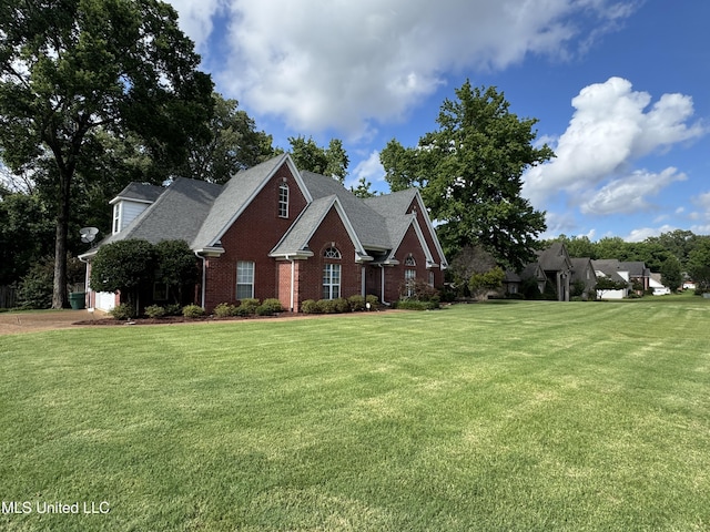 2610 Dickens Place Dr, Southaven, MS 38671 - view of front facade featuring brick siding, a front lawn, and roof with shingles