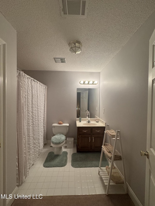 2610 Dickens Place Dr, Southaven, MS 38671 - bathroom featuring vanity, tile patterned flooring, a textured ceiling, and a shower with shower curtain
