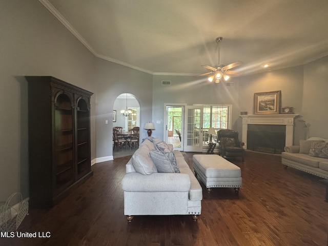 2610 Dickens Place Dr, Southaven, MS 38671 - living room featuring ornamental molding, a fireplace, dark wood-type flooring, a ceiling fan, and arched walkways