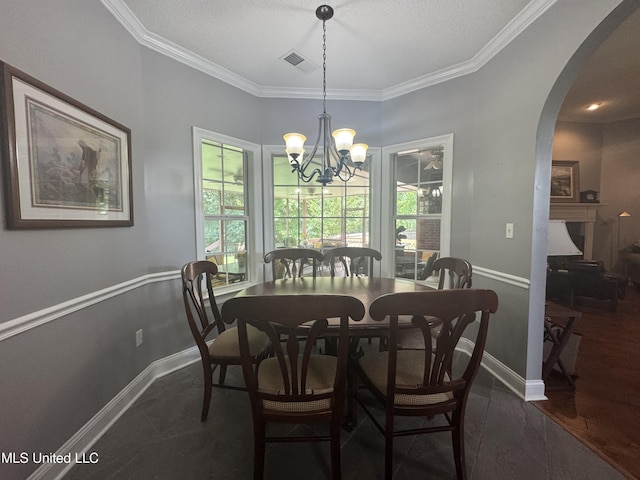 2610 Dickens Place Dr, Southaven, MS 38671 - dining room with healthy amount of natural light, ornamental molding, a chandelier, and arched walkways