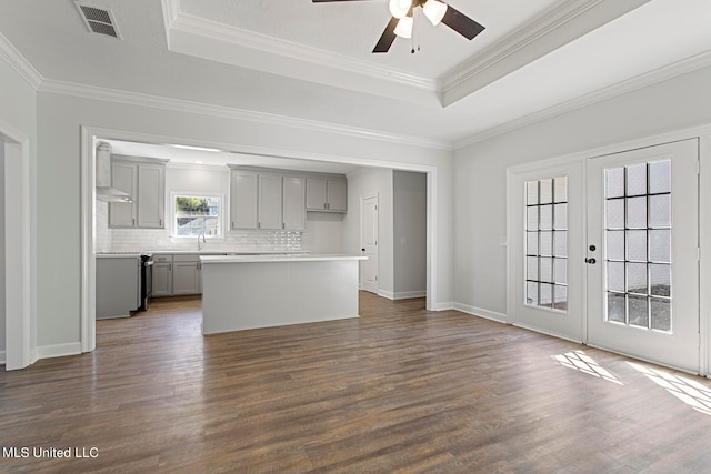 unfurnished living room with french doors, ornamental molding, ceiling fan, and dark hardwood / wood-style flooring