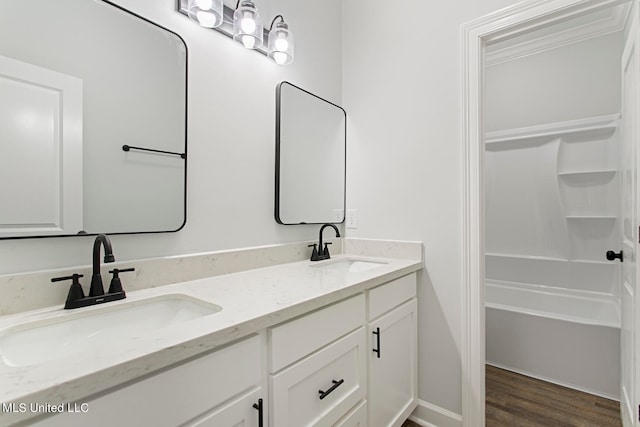 bathroom with vanity, hardwood / wood-style floors, and separate shower and tub