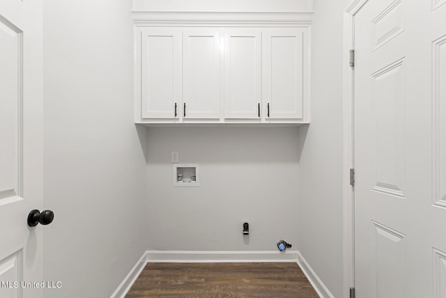 laundry area featuring washer hookup, dark hardwood / wood-style flooring, and cabinets