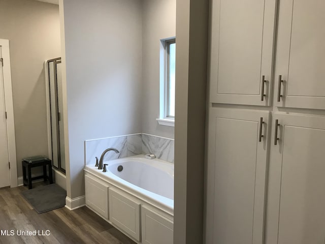 bathroom featuring hardwood / wood-style floors and shower with separate bathtub