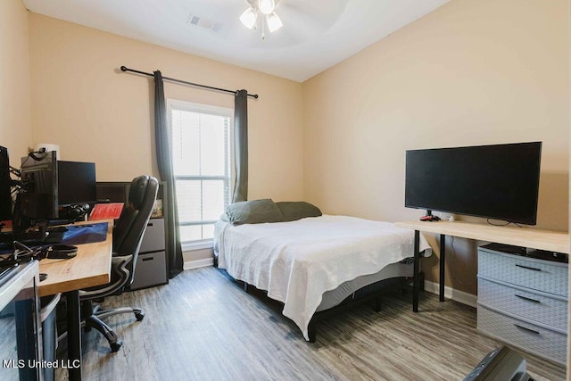 bedroom with hardwood / wood-style flooring and ceiling fan